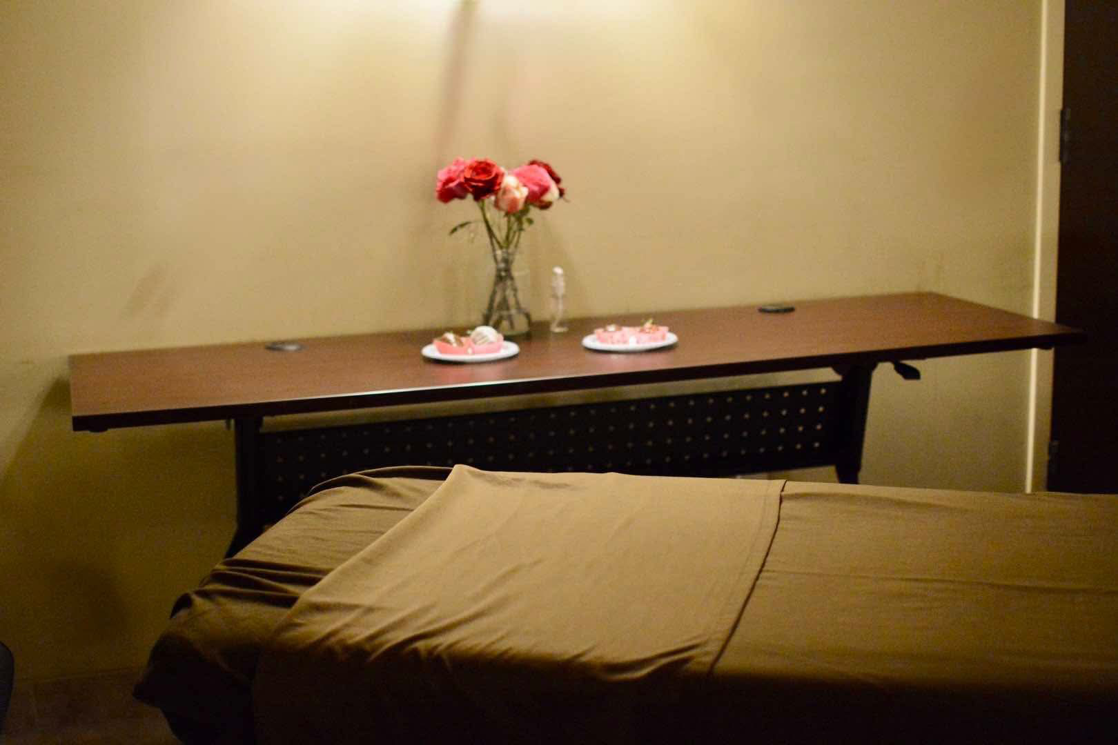 Licensed massage therapist providing chair massage in a professional workplace wellness setting