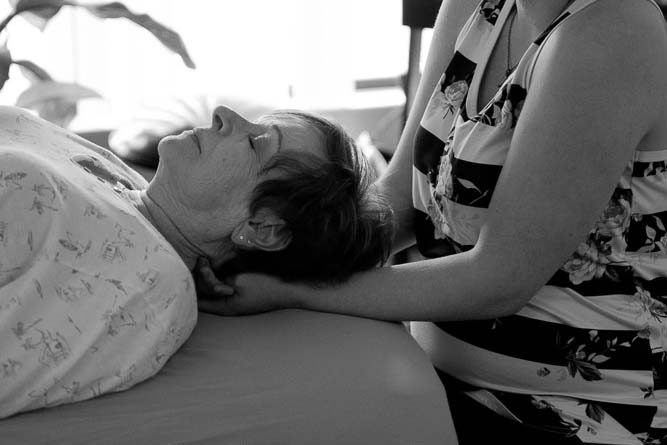 Therapist using gentle manual therapy techniques adapted to a client's comfort level